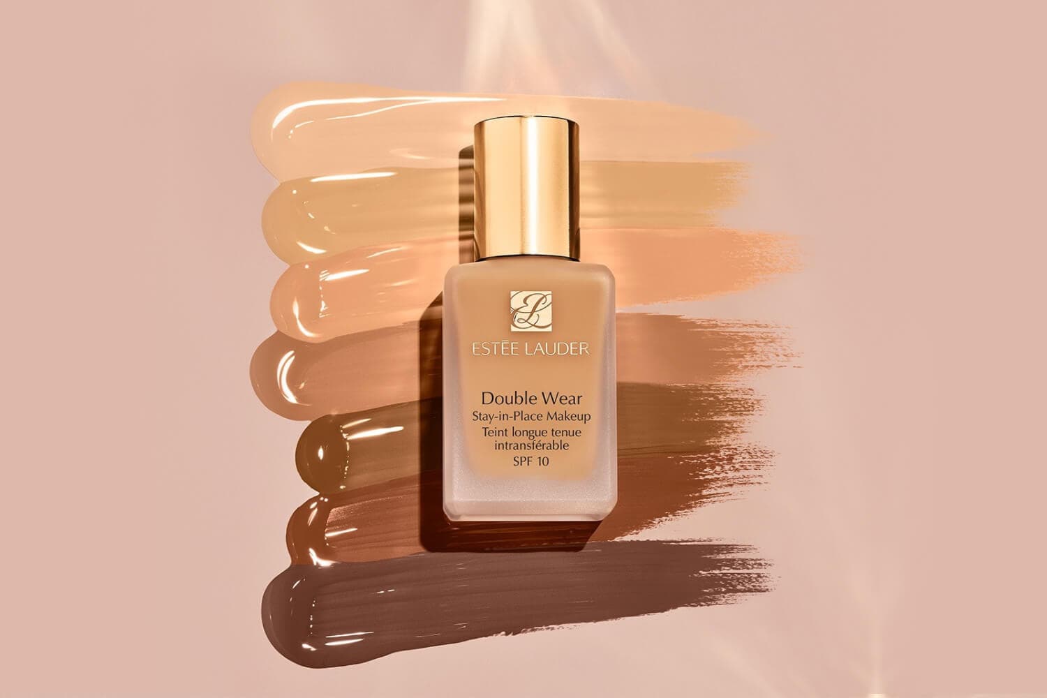 Estée Lauder Double Wear Stay-in-Place Makeup SPF 10 bottle on a fan of foundation swatches from fair to deep. Estée Lauder Double Wear Stay-in-Place Makeup SPF 10 bottle on a fan of foundation swatches from fair to deep.