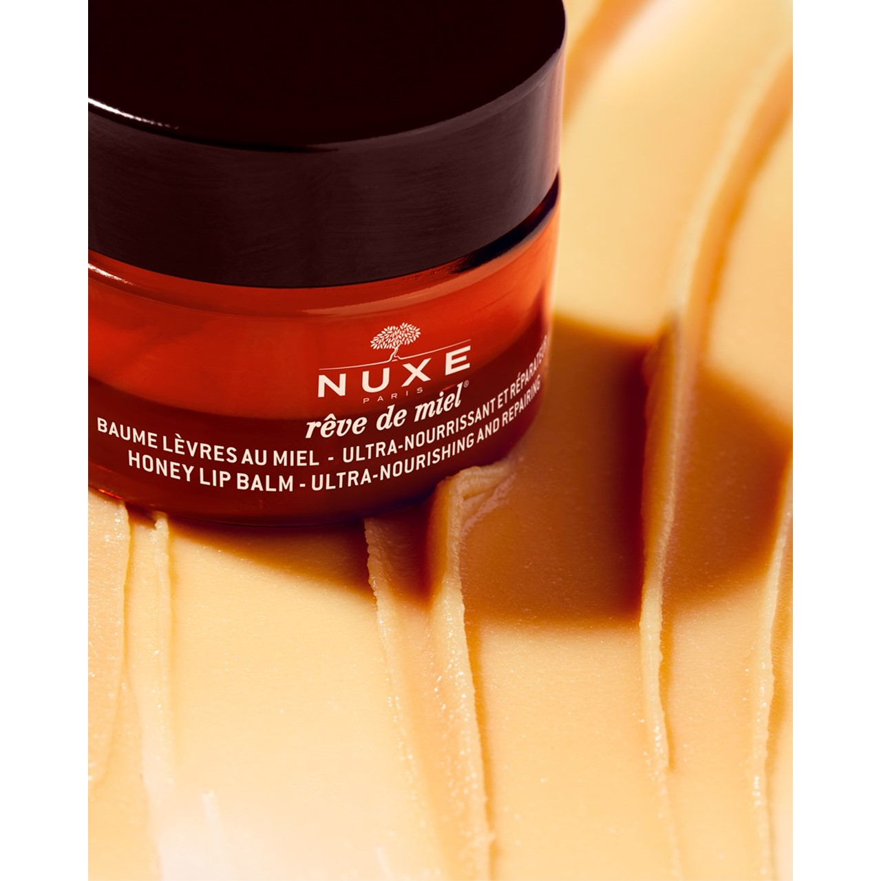 NUXE Rêve de Miel بلسم شفاه بالعسل مغذٍّ ومُصلِح للغاية 15g