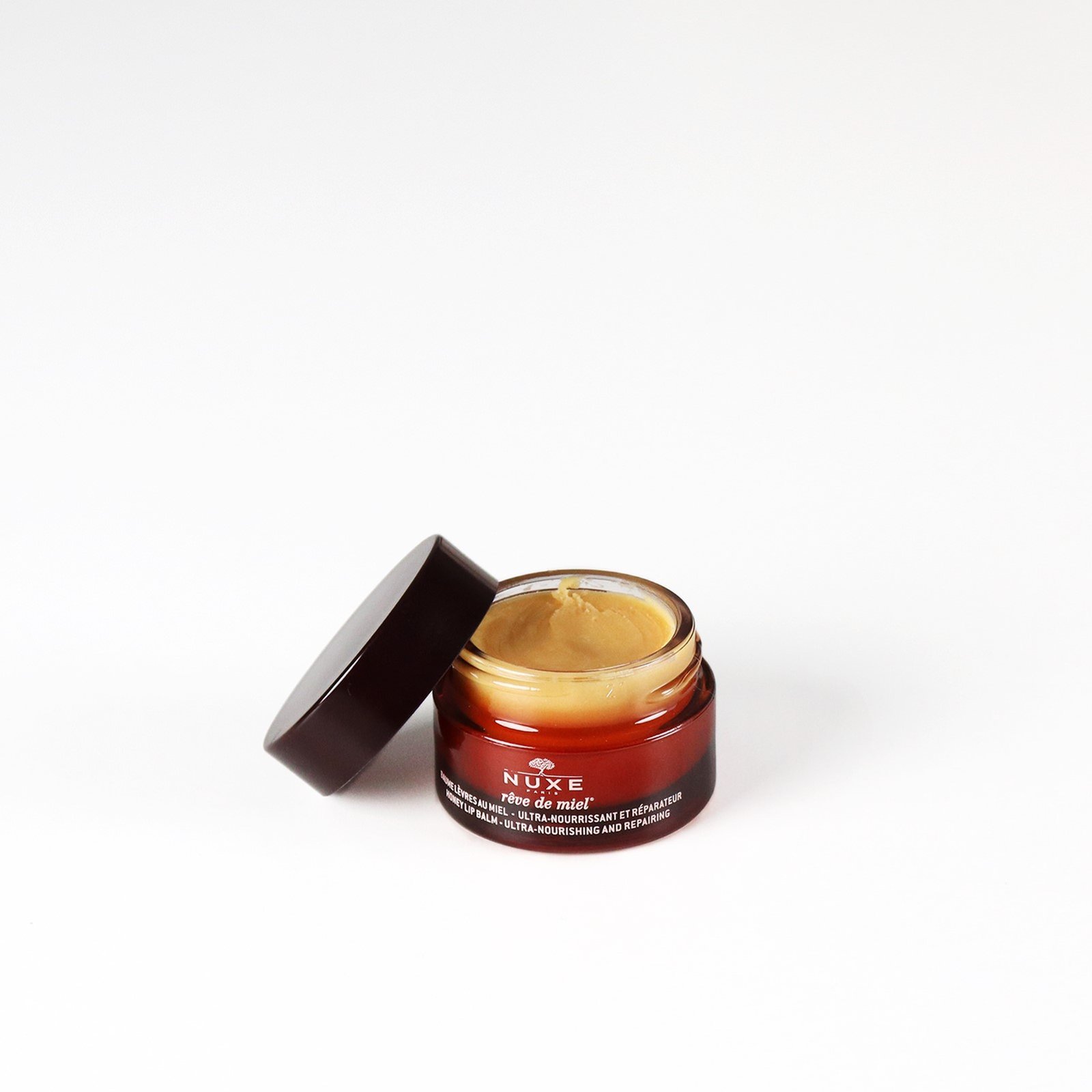 NUXE Rêve de Miel بلسم شفاه بالعسل مغذٍّ ومُصلِح للغاية 15g