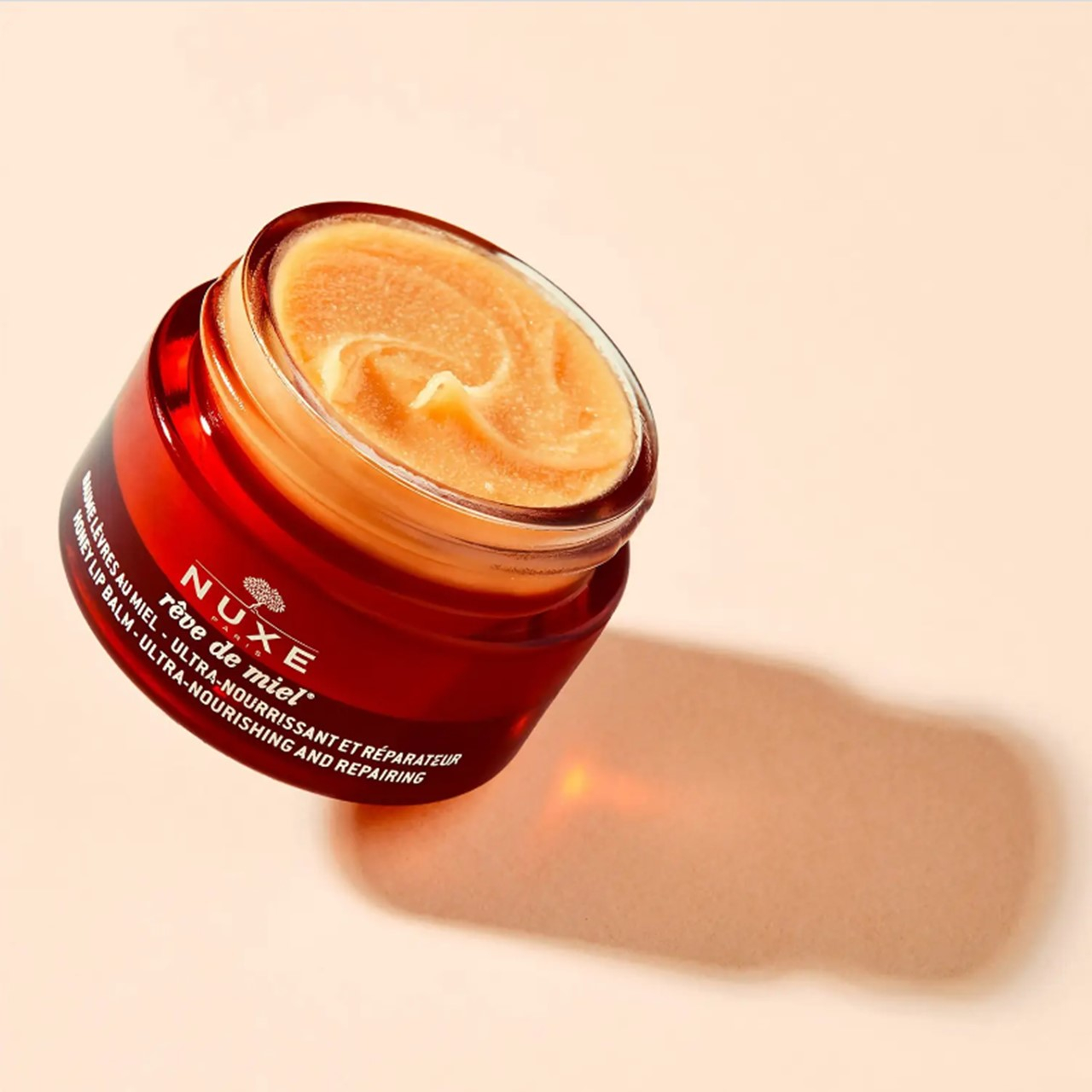 NUXE Rêve de Miel بلسم شفاه بالعسل مغذٍّ ومُصلِح للغاية 15g