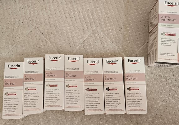 Multiple Eucerin Anti-Pigment Spot Corrector and Dual Serum product boxes arranged on a textured surface. review
